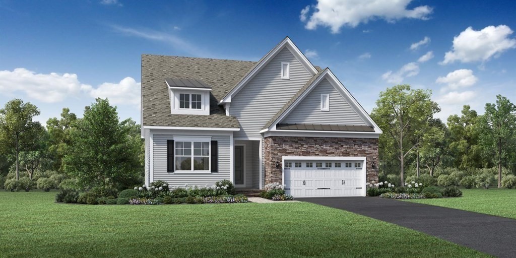 a front view of a house with a garden and yard