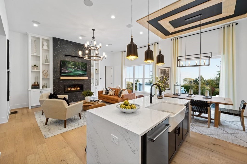 27 Barnes Boulevard, Unit 13 Hudson, MA 01749 - Photo 2 of 12 a living room with fireplace furniture and a flat screen tv