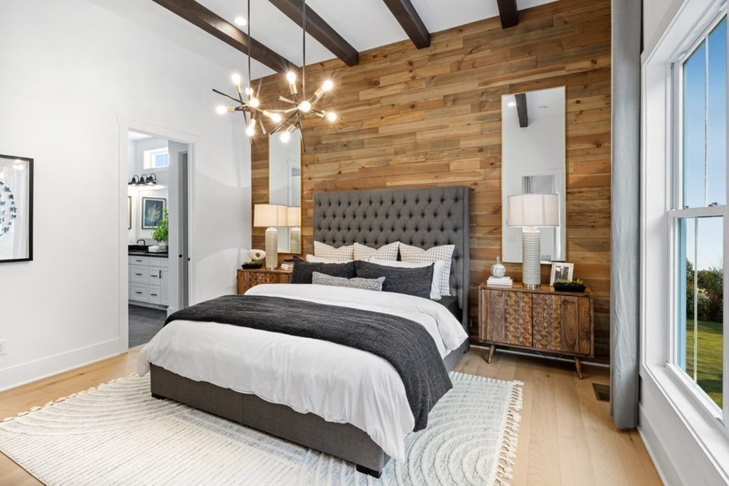 27 Barnes Boulevard, Unit 13 Hudson, MA 01749 - Photo 6 of 12 a bedroom with a bed and a chandelier