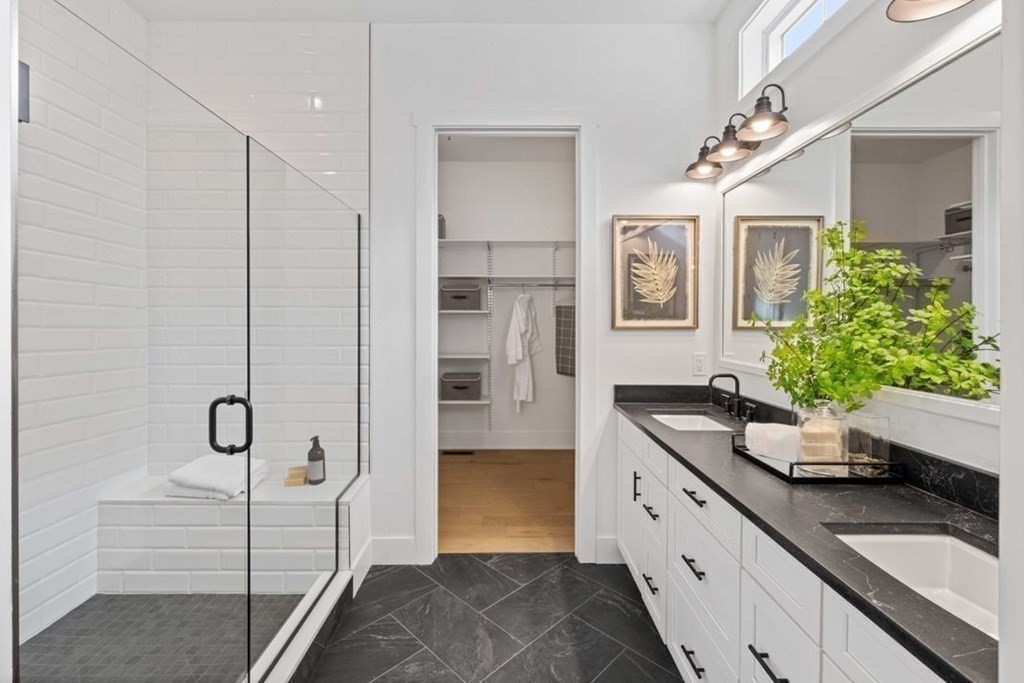 27 Barnes Boulevard, Unit 13 Hudson, MA 01749 - Photo 7 of 12 a bathroom with a granite countertop sink a mirror and shower