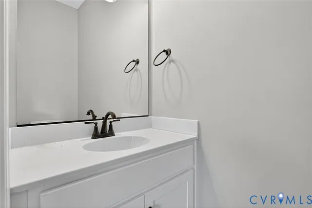 a bathroom with a sink and mirror