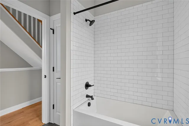 a bathroom with a bathtub and shower