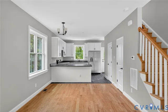 a kitchen with stainless steel appliances granite countertop a refrigerator and a sink
