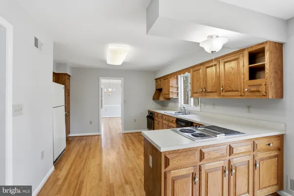 a large kitchen with stainless steel appliances granite countertop a stove and a sink