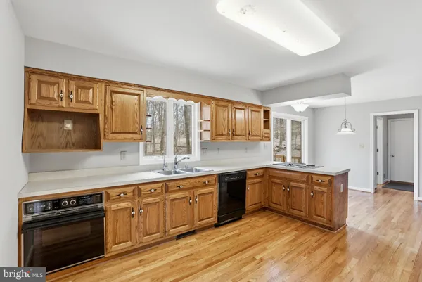 a kitchen with stainless steel appliances a refrigerator and a stove top oven