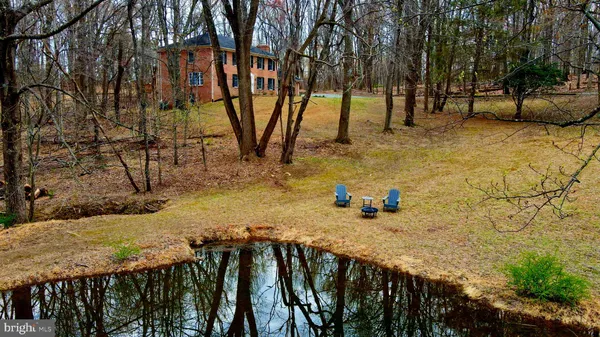 a swimming pool with outdoor seating and yard