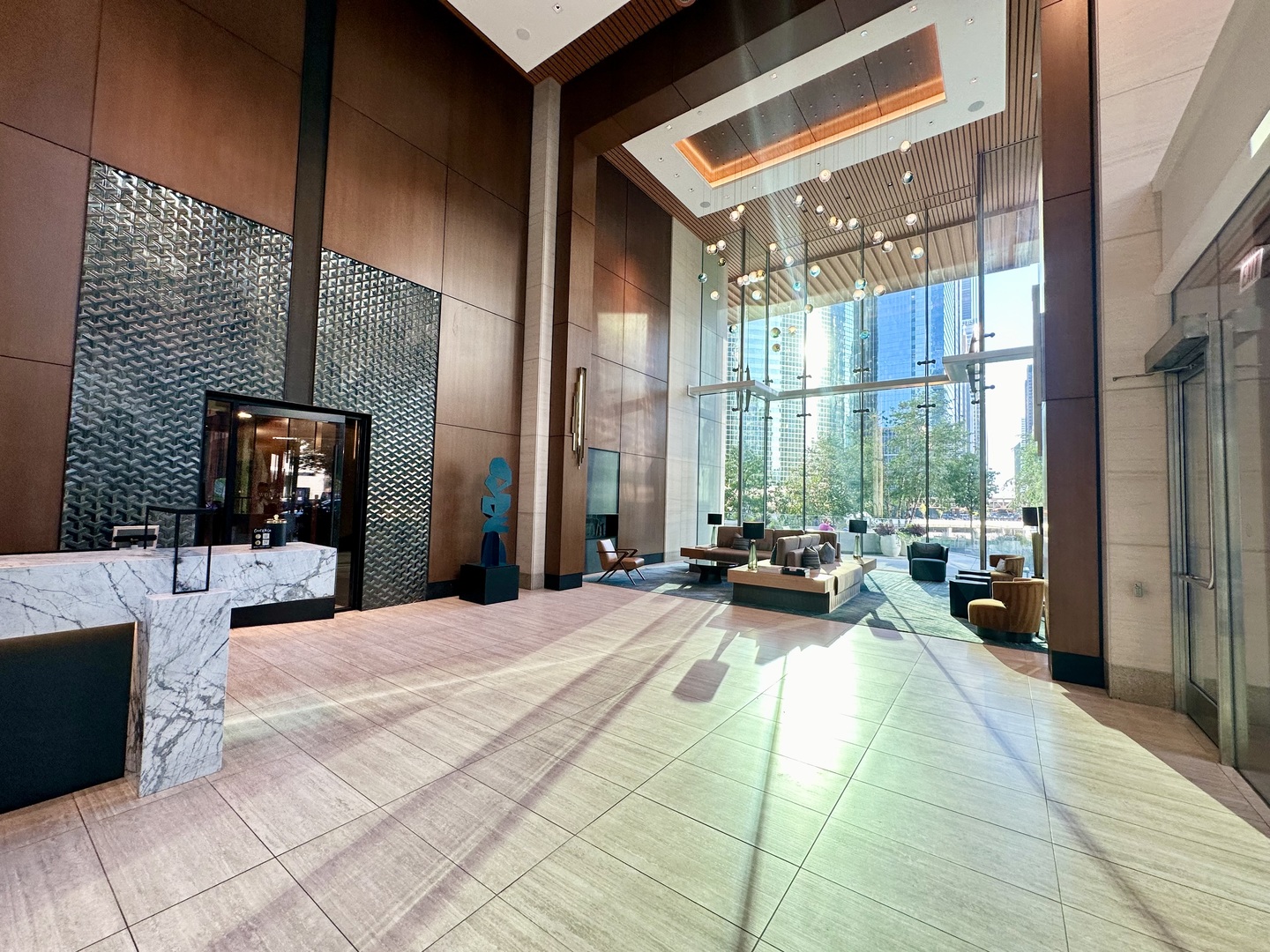 313 West Wolf Point Plaza, Unit 1910 Chicago, IL 60654 - Photo 2 of 30 a view of a lobby with furniture and floor to ceiling window