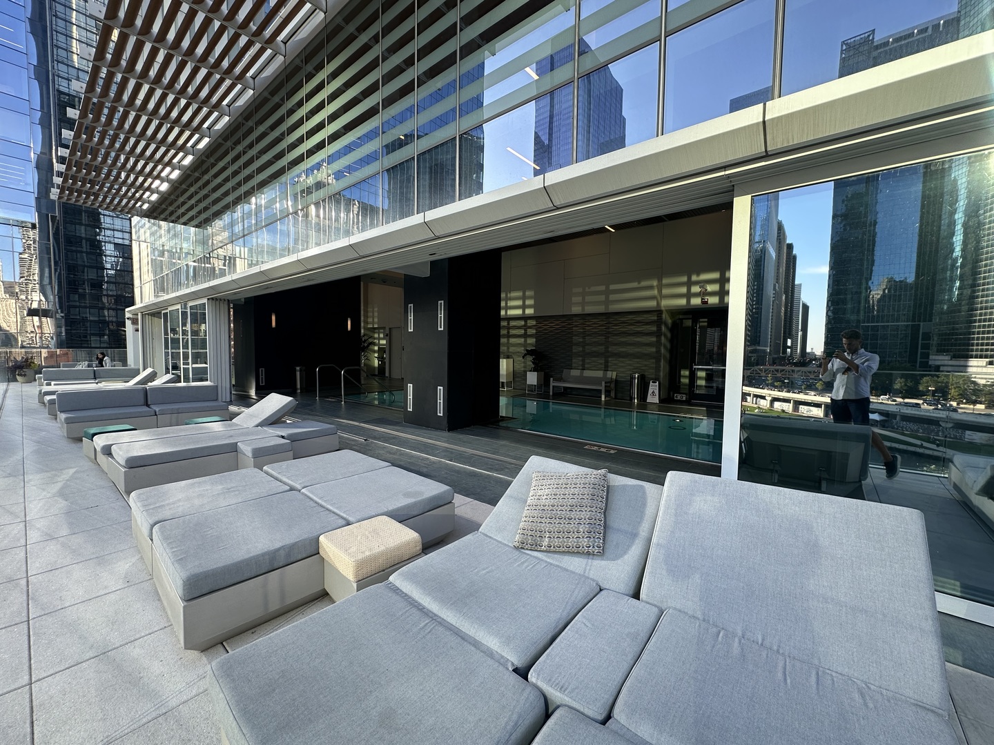 313 West Wolf Point Plaza, Unit 1910 Chicago, IL 60654 - Photo 25 of 30 a view of a patio with table and chairs potted plants and large tree