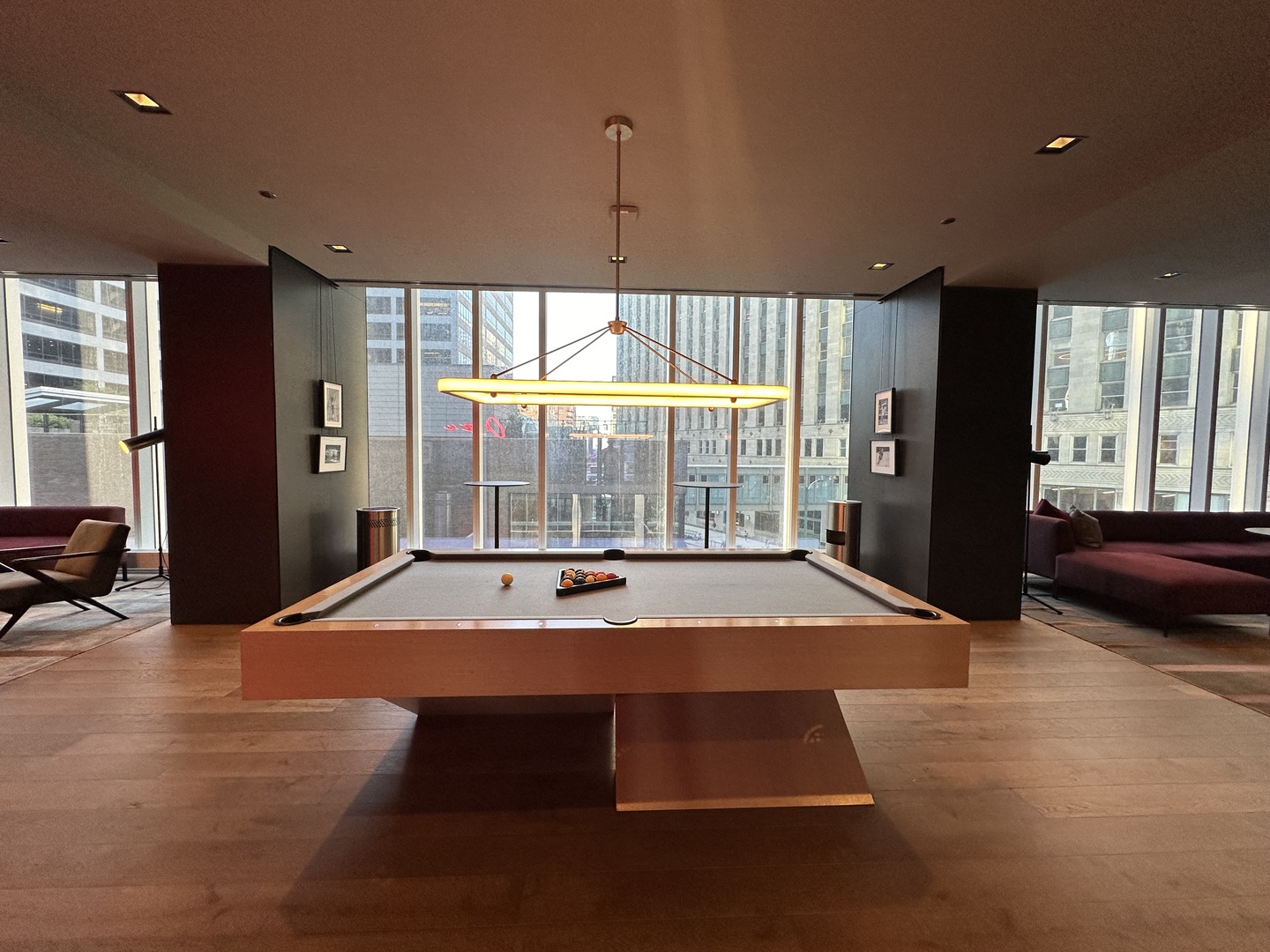 313 West Wolf Point Plaza, Unit 1910 Chicago, IL 60654 - Photo 27 of 30 a room with pool table and a chandelier