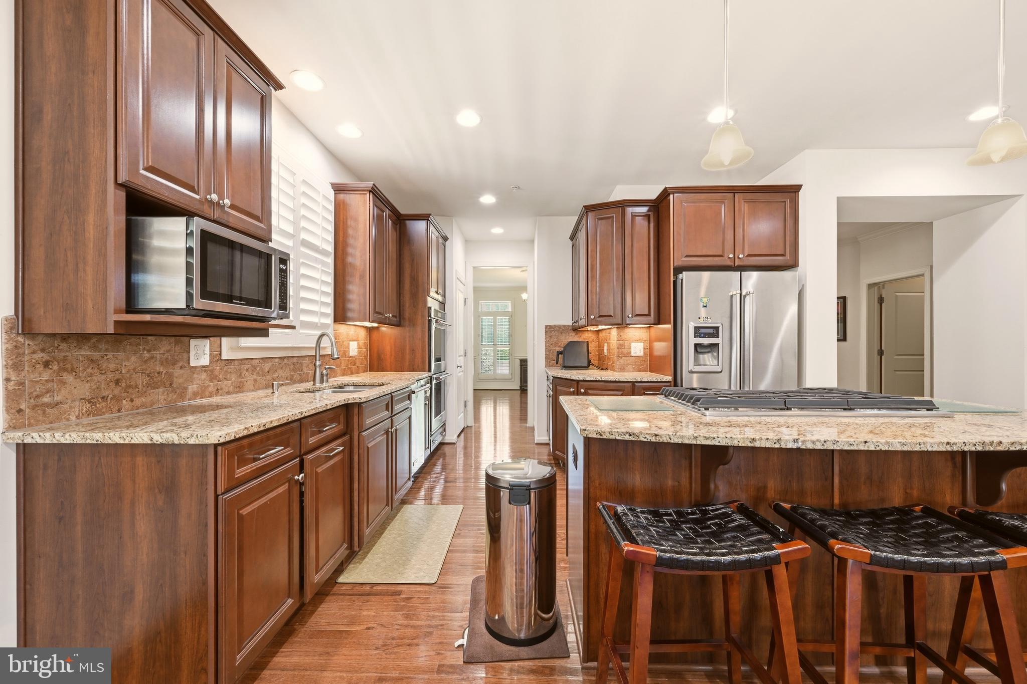 1104 Sweetbay Place Silver Spring, MD 20906 - Photo 14 of 43 a kitchen with stainless steel appliances granite countertop a stove and a sink