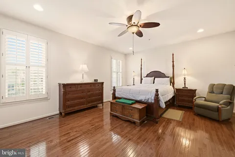 a bedroom with furniture and wooden floor