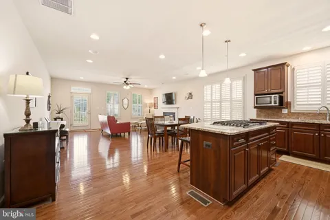 a kitchen with lots of counter top space and painting on the wall