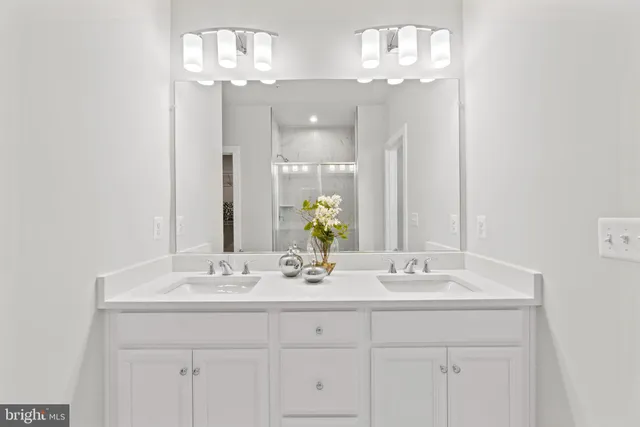 a bathroom with a sink double vanity and a mirror