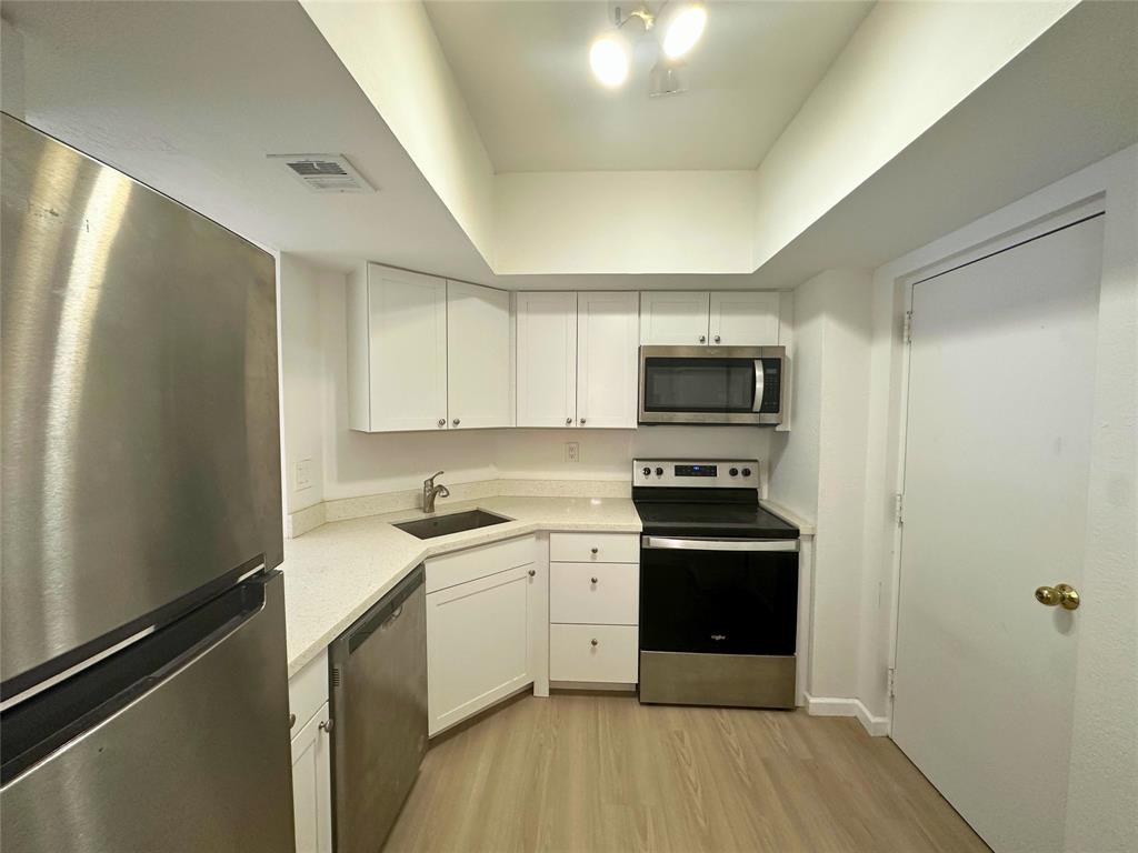 50 Southwest 3rd Avenue, Unit 110 Boca Raton, FL 33432 - Photo 2 of 21 a kitchen with a sink stainless steel appliances and cabinets