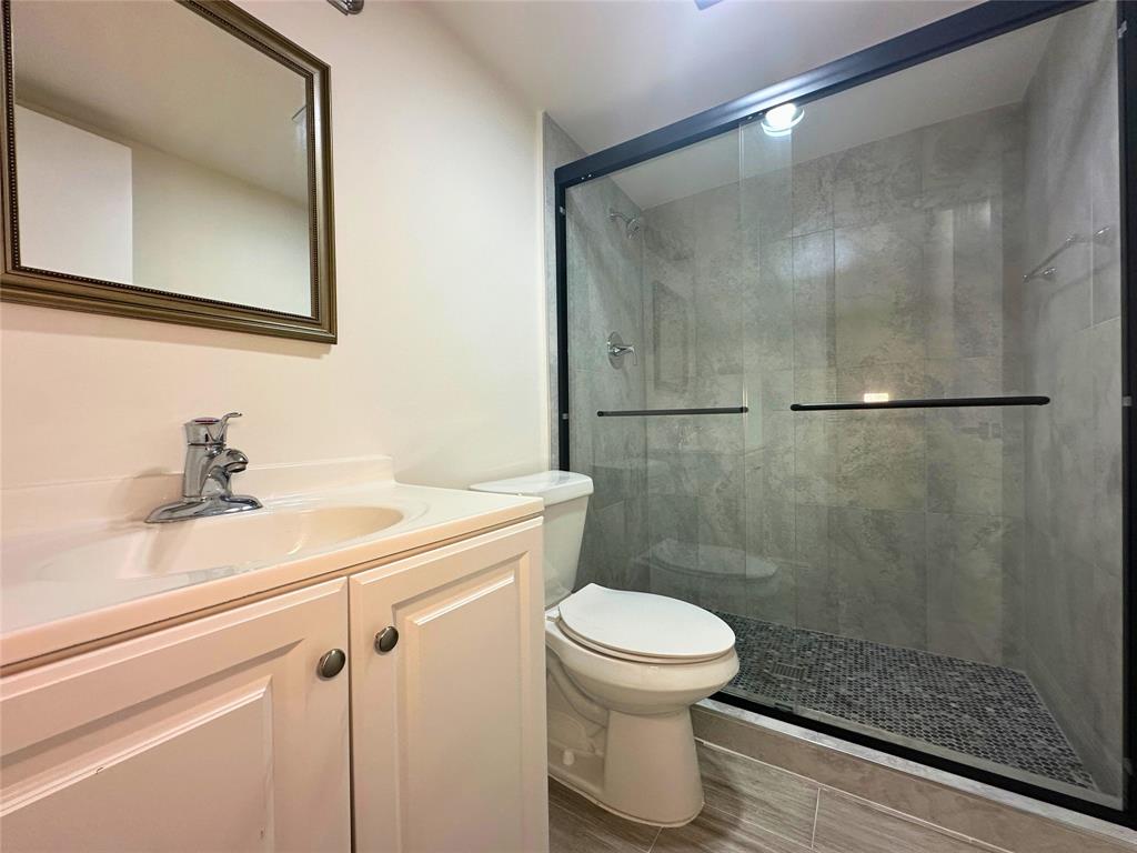 50 Southwest 3rd Avenue, Unit 110 Boca Raton, FL 33432 - Photo 21 of 21 a bathroom with a sink a toilet and a shower