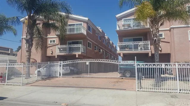 a view of a brick building next to a yard