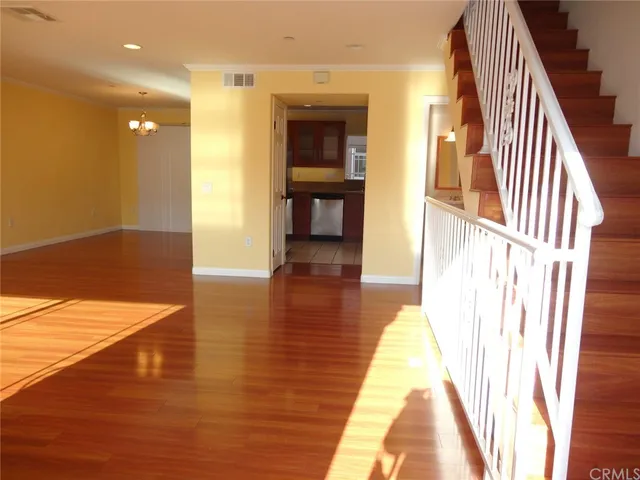 a view of entryway and hall with wooden floor