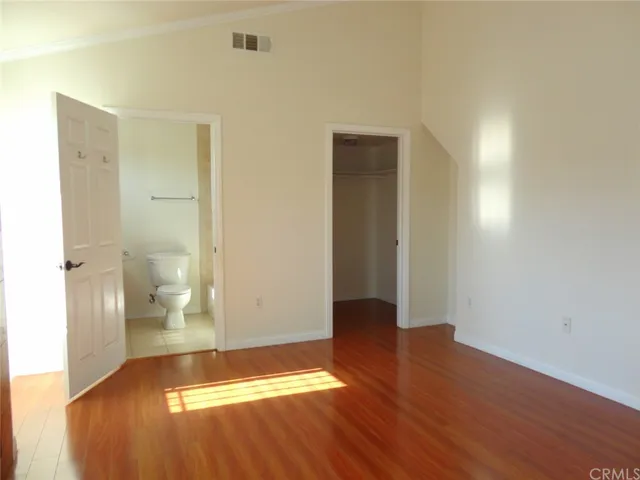 a bathroom with a granite countertop toilet sink and mirror