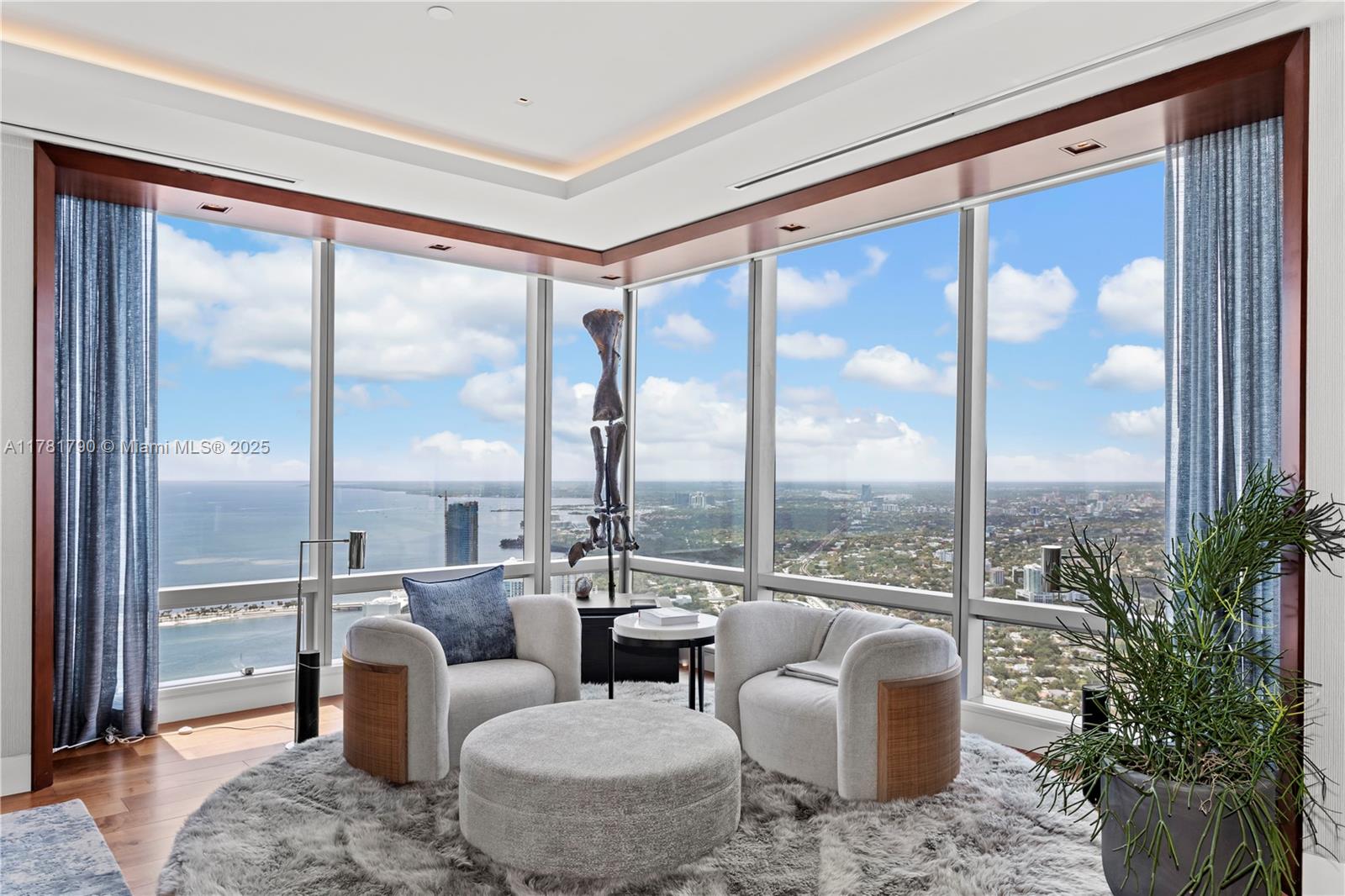1425 Brickell Avenue, Unit PH4BCD Miami, FL 33131 - Photo 2 of 28 a living room with furniture and a floor to ceiling window
