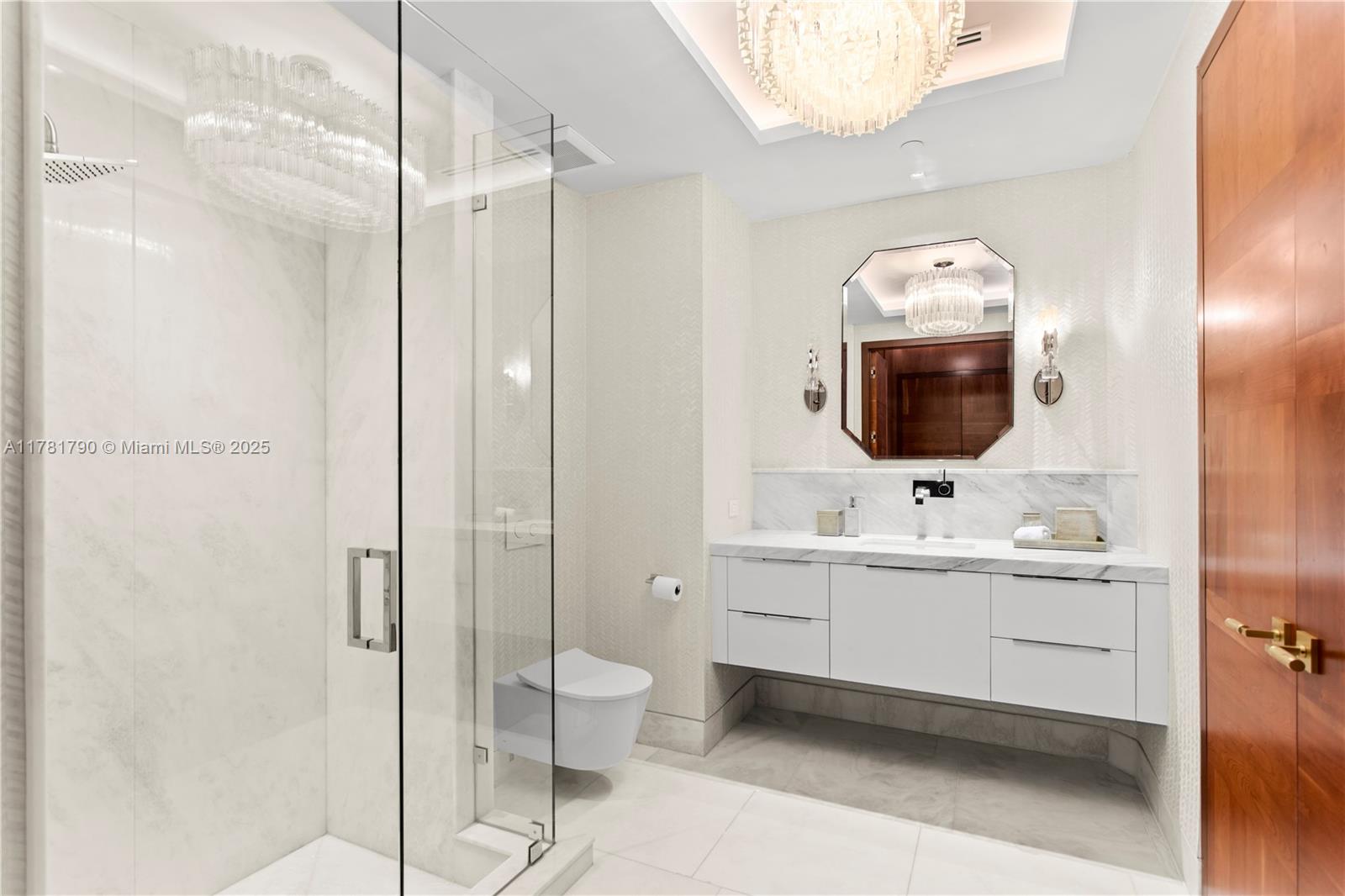 1425 Brickell Avenue, Unit PH4BCD Miami, FL 33131 - Photo 24 of 28 a bathroom with a toilet sink and mirror