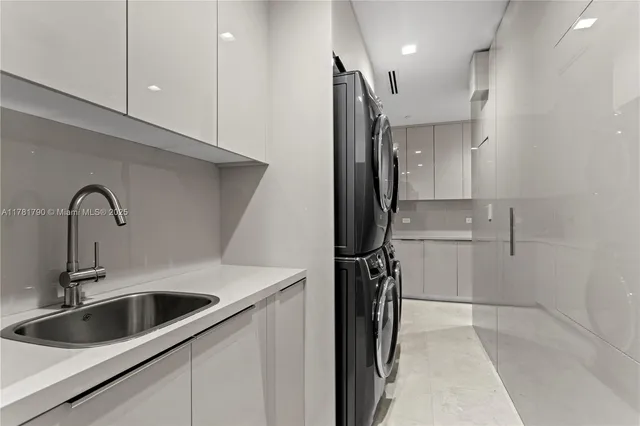 a kitchen with a refrigerator sink and cabinets