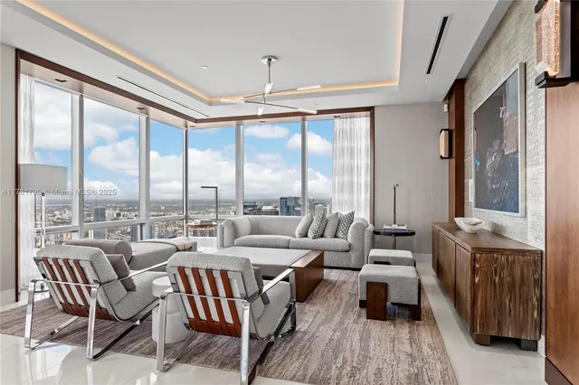 a very nice looking living room with a large window and furniture