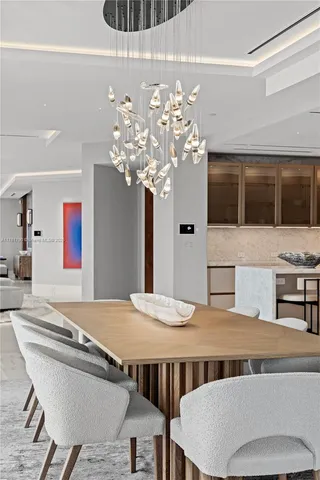 a dining room with furniture and chandelier