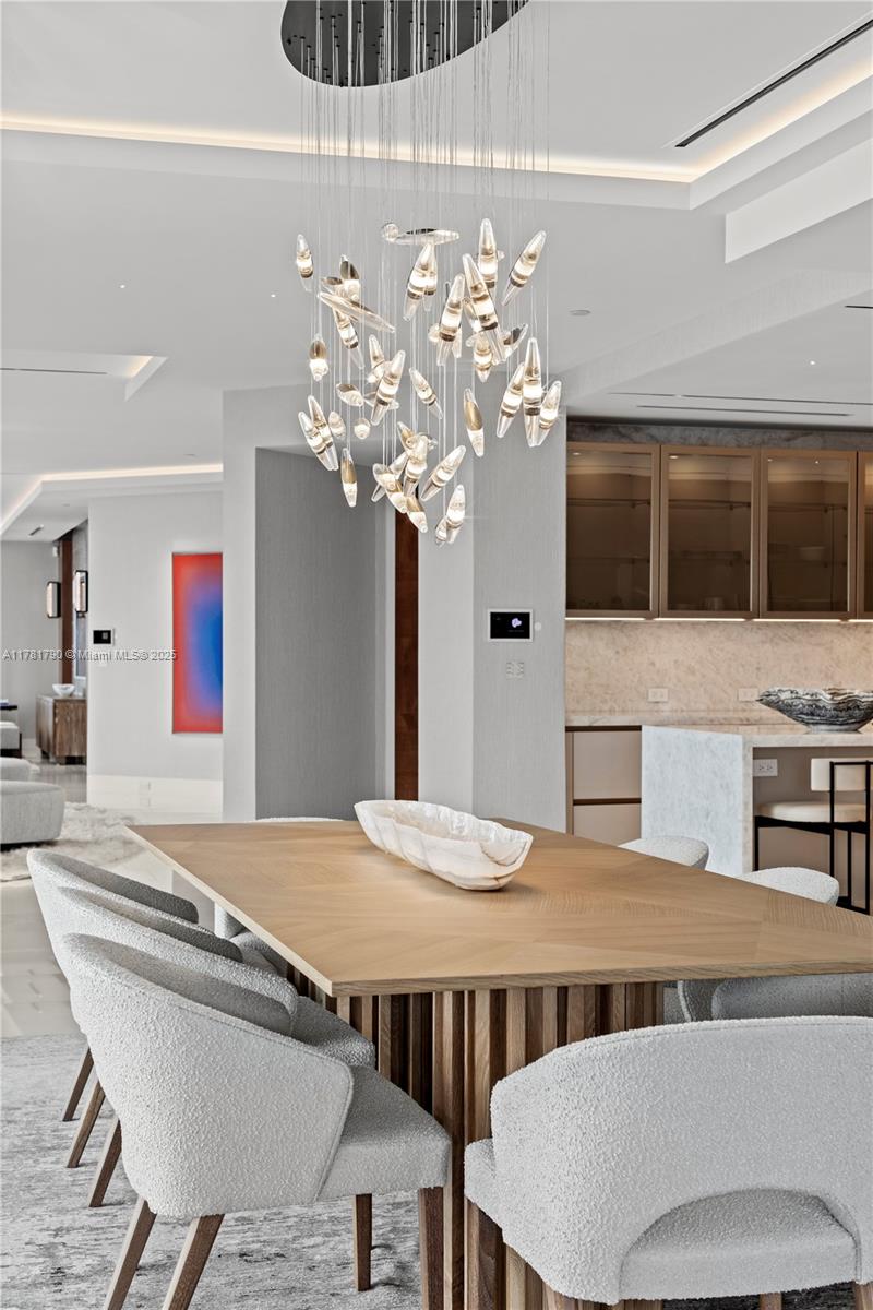 1425 Brickell Avenue, Unit PH4BCD Miami, FL 33131 - Photo 5 of 28 a dining room with furniture and chandelier