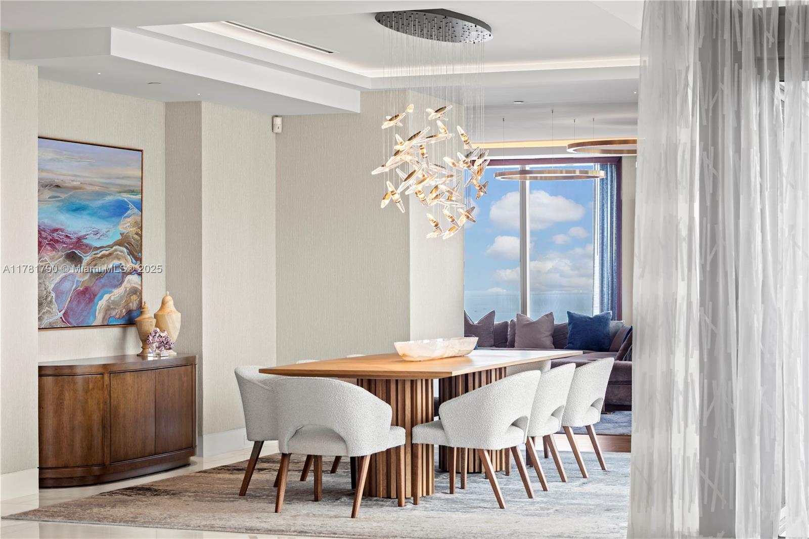 1425 Brickell Avenue, Unit PH4BCD Miami, FL 33131 - Photo 8 of 28 a view of a dining room with furniture and chandelier