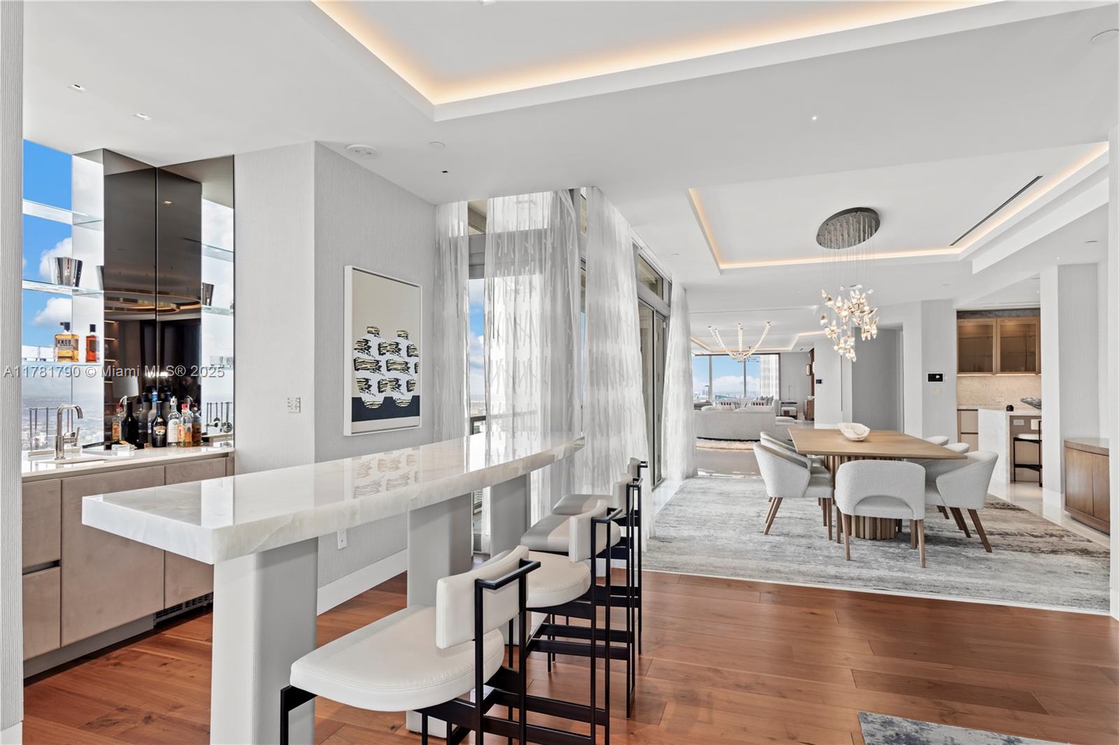 1425 Brickell Avenue, Unit PH4BCD Miami, FL 33131 - Photo 10 of 28 a view of a dining room with furniture and wooden floor