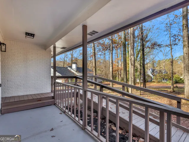 a view of a porch with wooden floor and outdoor space