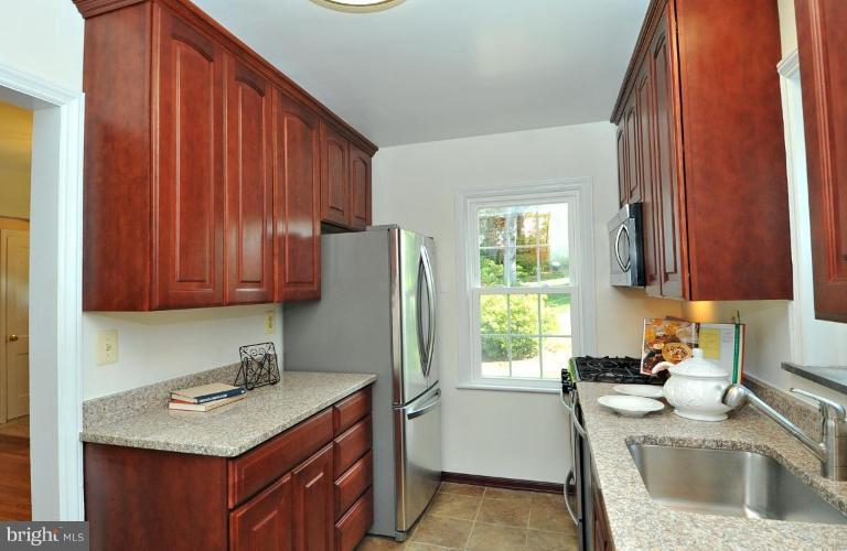 9518 St Andrews Way Silver Spring, MD 20901 - Photo 12 of 29 a kitchen with a sink stove and refrigerator