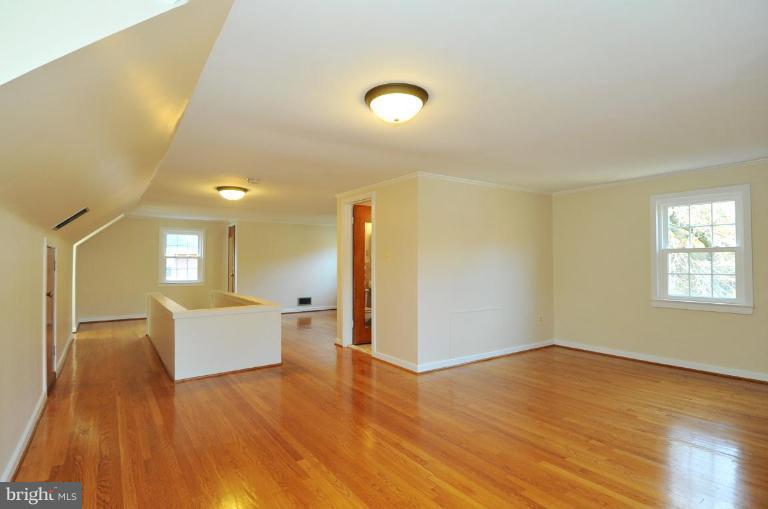 9518 St Andrews Way Silver Spring, MD 20901 - Photo 17 of 29 a view of a big room with wooden floor and windows