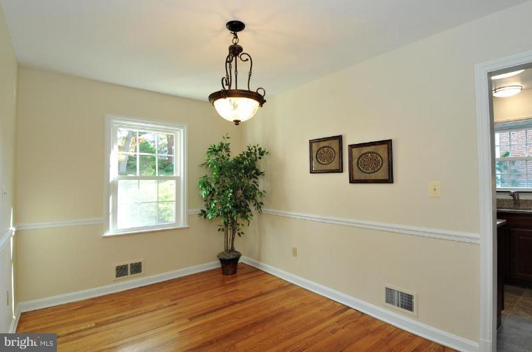 9518 St Andrews Way Silver Spring, MD 20901 - Photo 9 of 29 a view of an empty room with a window and wooden floor