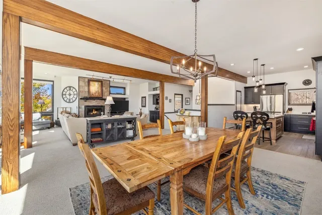 a dining table with chairs and kitchen view
