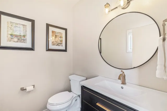 a bathroom with a sink a mirror a toilet and a mirror