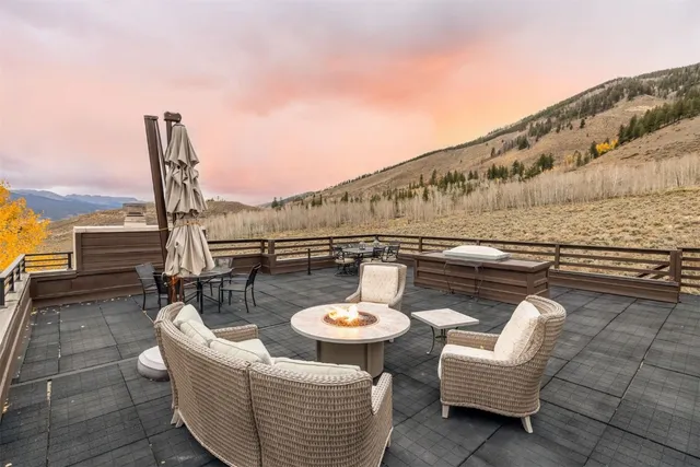 a balcony with table and chairs