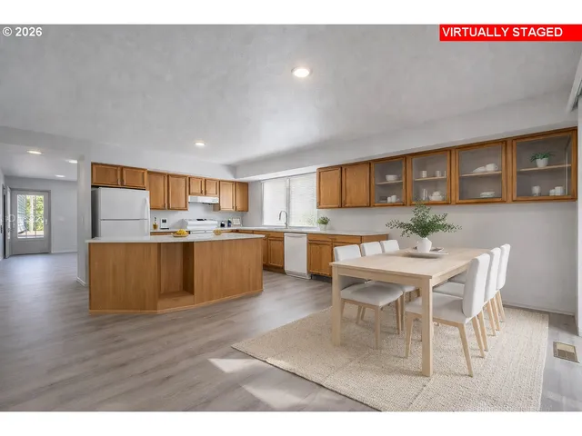 a living room with stainless steel appliances kitchen island granite countertop furniture a rug kitchen view and a window