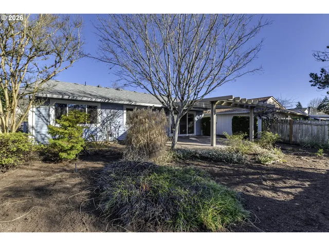 a view of a house with backyard and sitting area