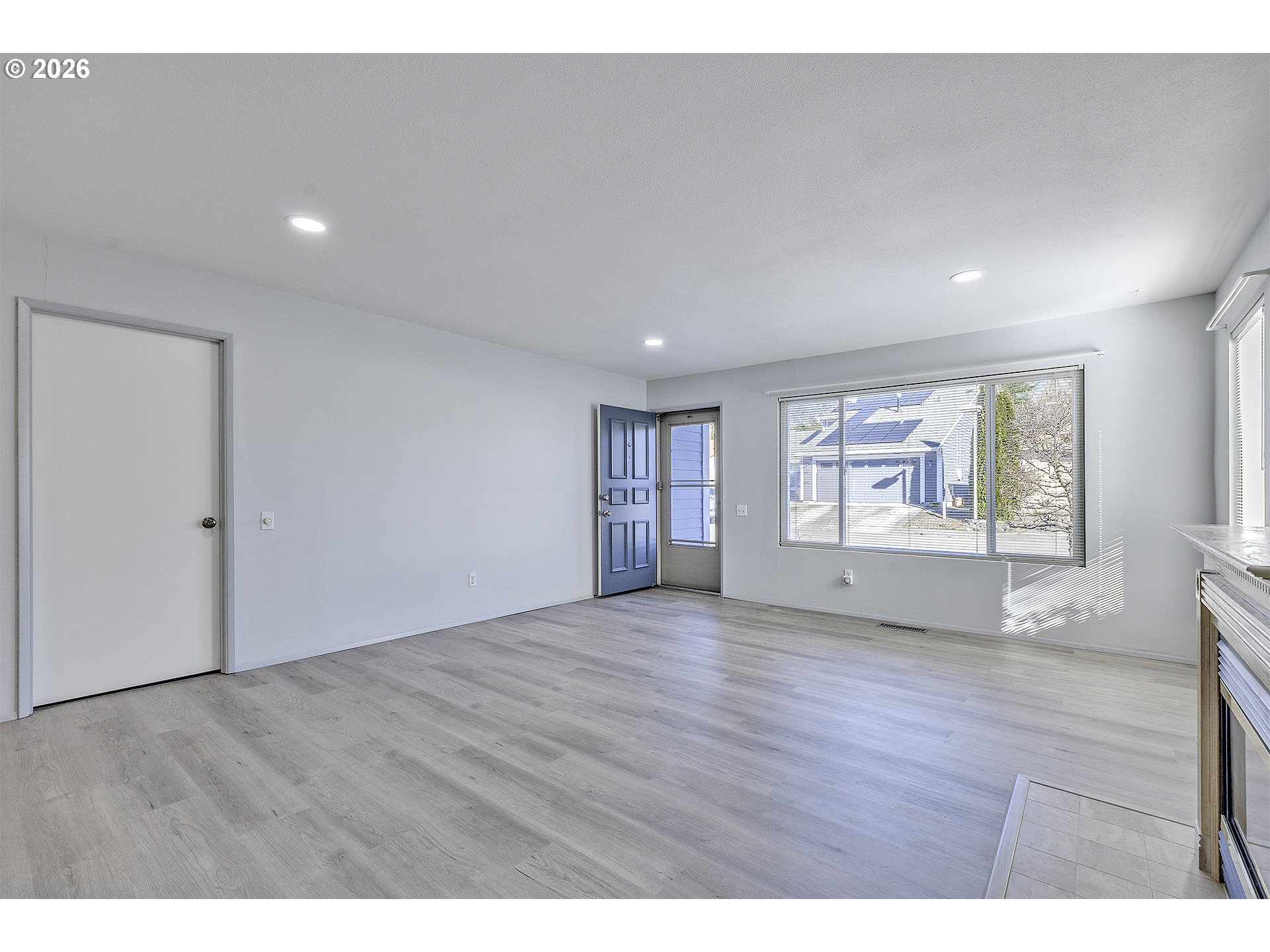 15765 Southwest Highland Court Portland, OR 97224 - Photo 5 of 30 a view of an empty room with wooden floor and a window