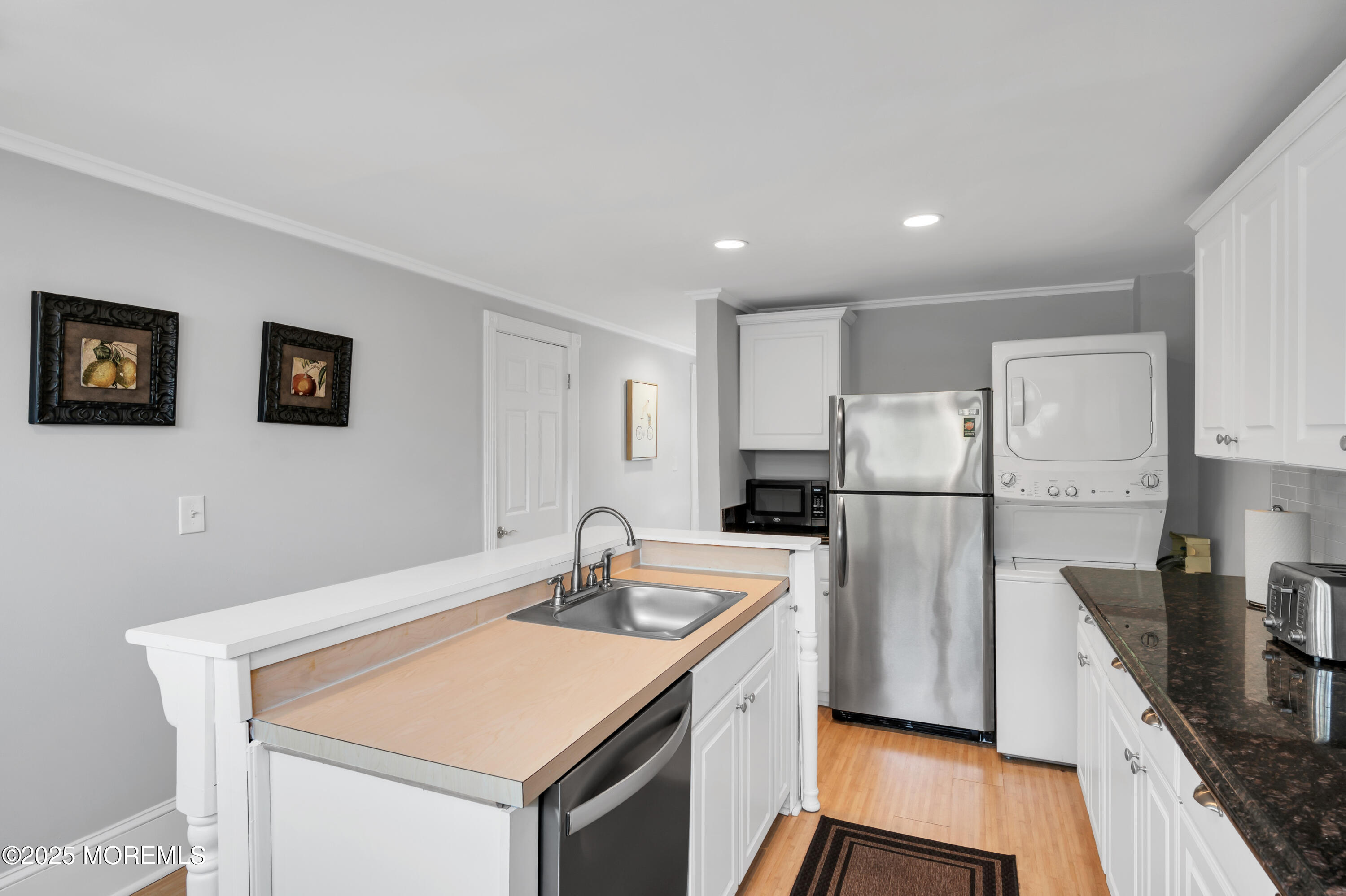 512 Main Avenue, Unit 4 Point Pleasant Beach, NJ 08742 - Photo 16 of 38 a kitchen with refrigerator and stove