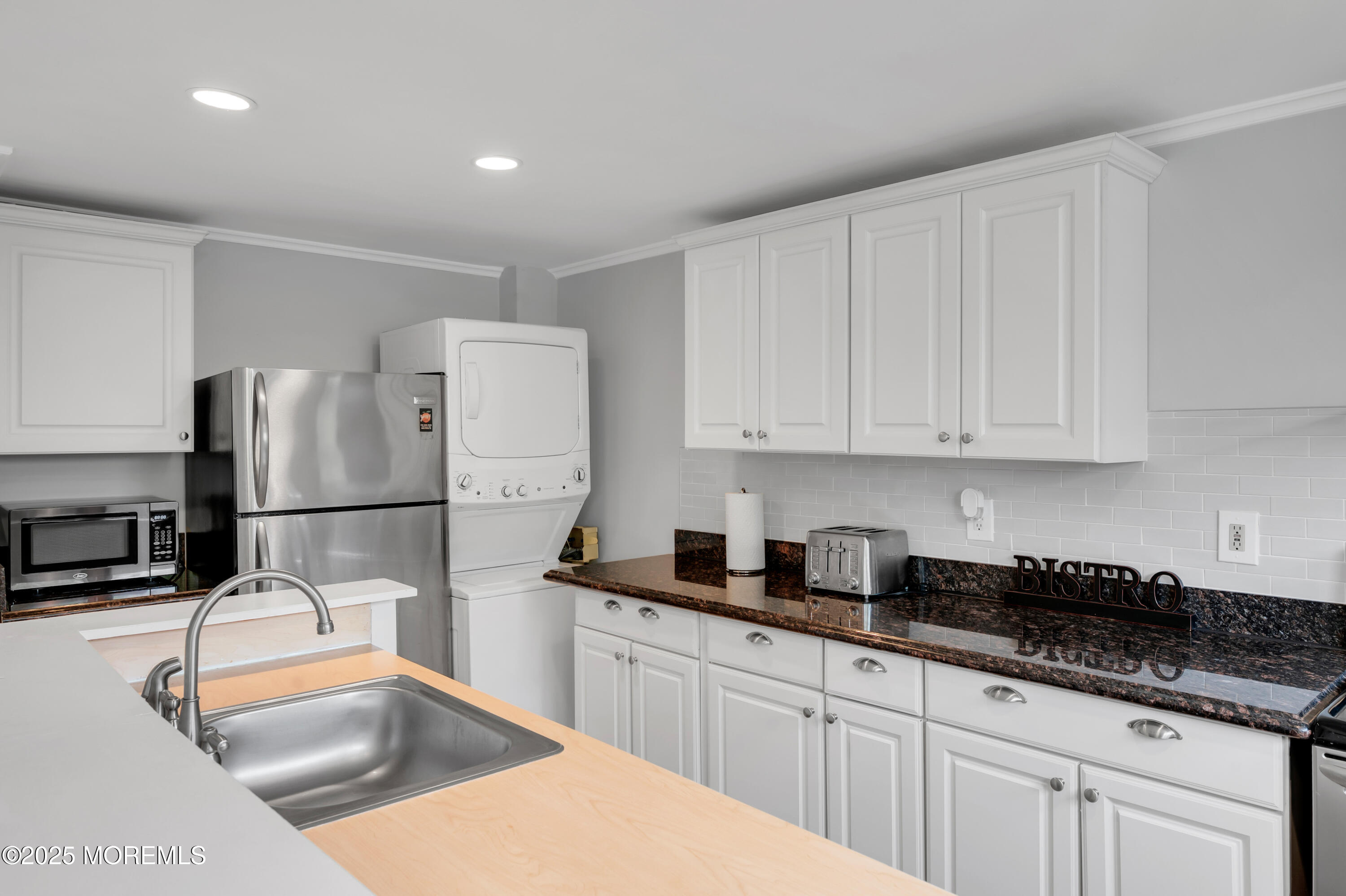 512 Main Avenue, Unit 4 Point Pleasant Beach, NJ 08742 - Photo 17 of 38 a kitchen with stainless steel appliances granite countertop a sink a stove a refrigerator a counter top space and cabinets