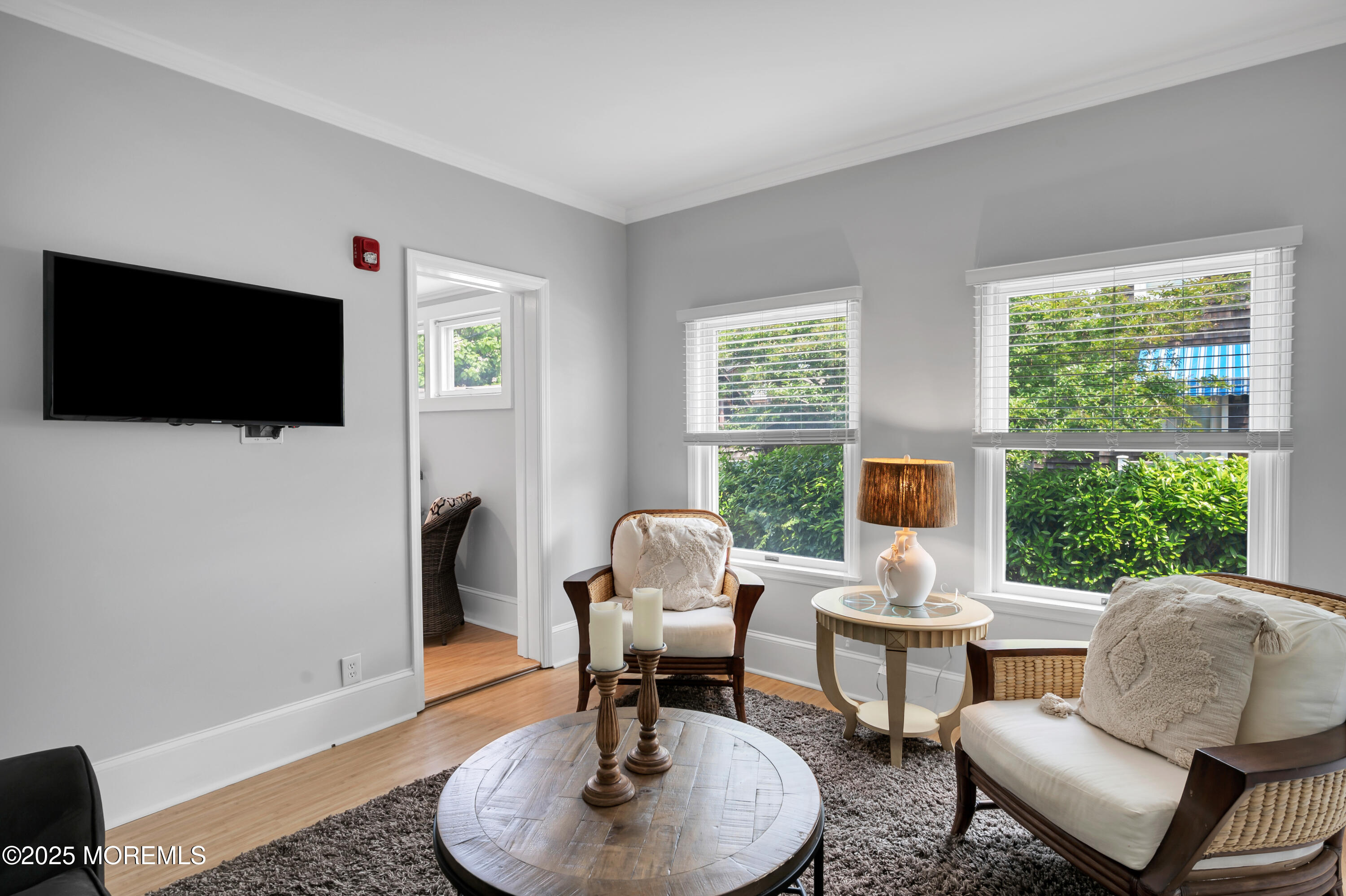 512 Main Avenue, Unit 4 Point Pleasant Beach, NJ 08742 - Photo 19 of 38 a living room with furniture a flat screen tv and a large window
