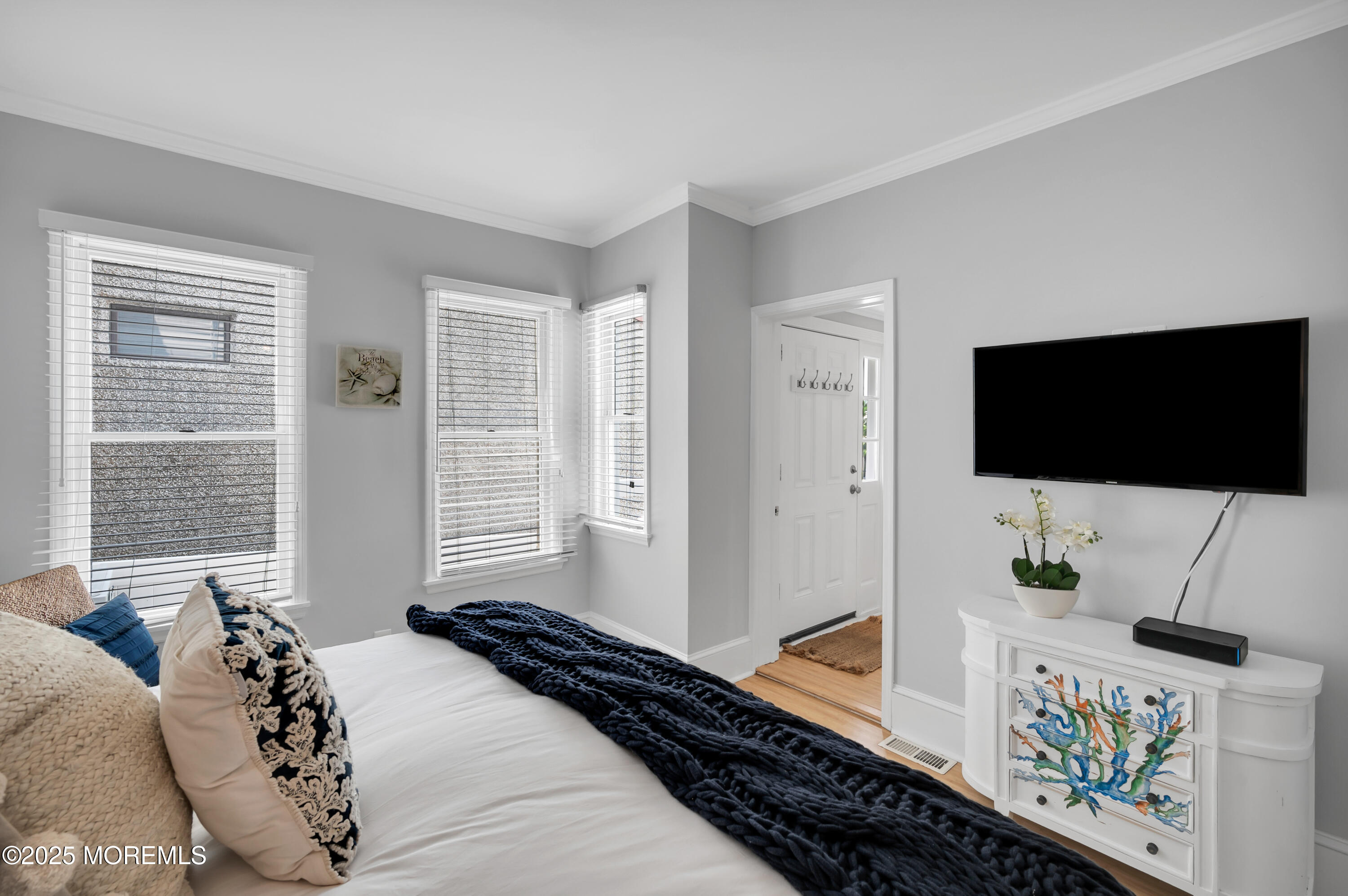 512 Main Avenue, Unit 4 Point Pleasant Beach, NJ 08742 - Photo 4 of 38 a bedroom with a bed and flat screen tv