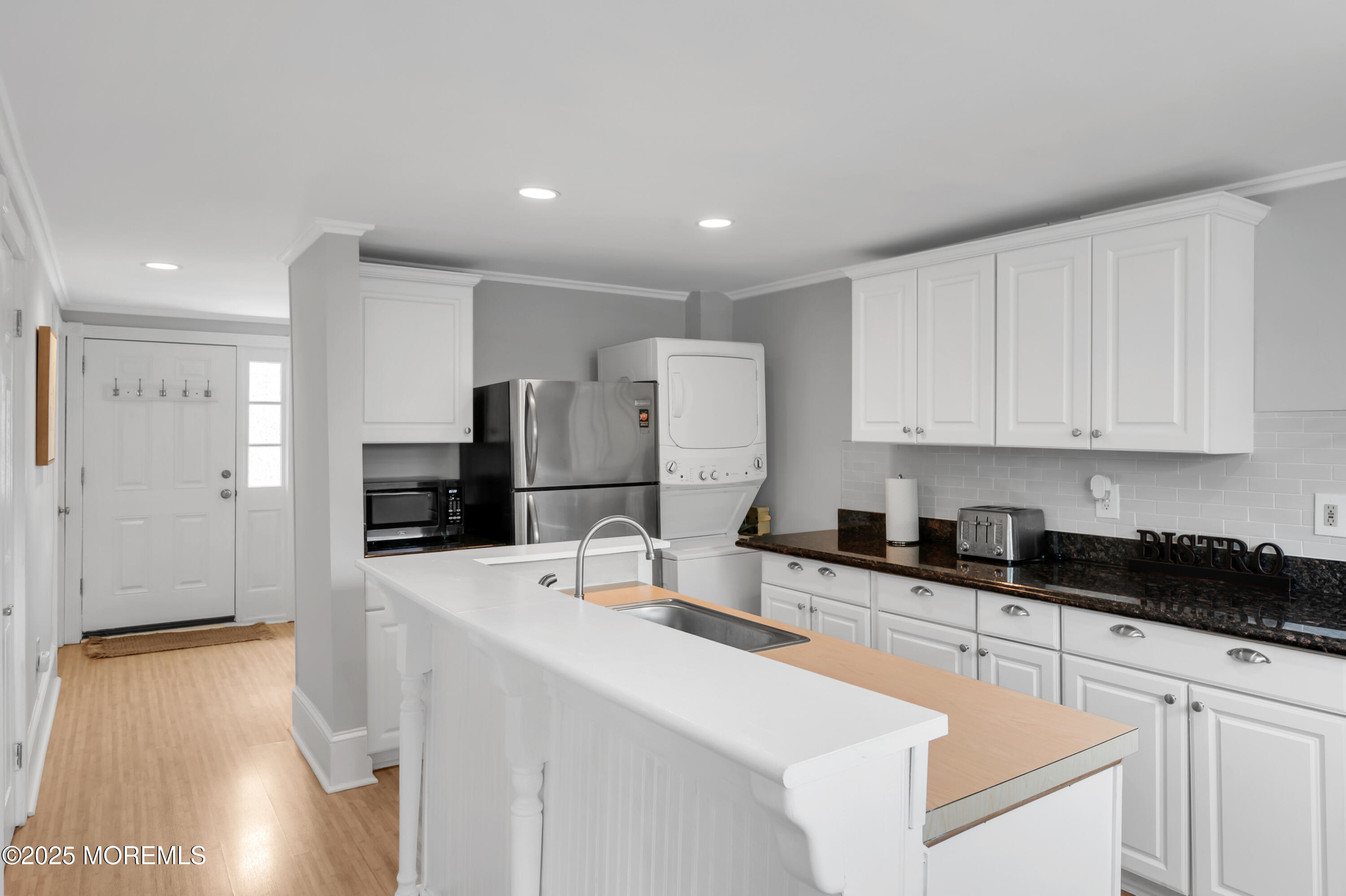 512 Main Avenue, Unit 4 Point Pleasant Beach, NJ 08742 - Photo 10 of 38 a kitchen with granite countertop a sink a stove a refrigerator and cabinets