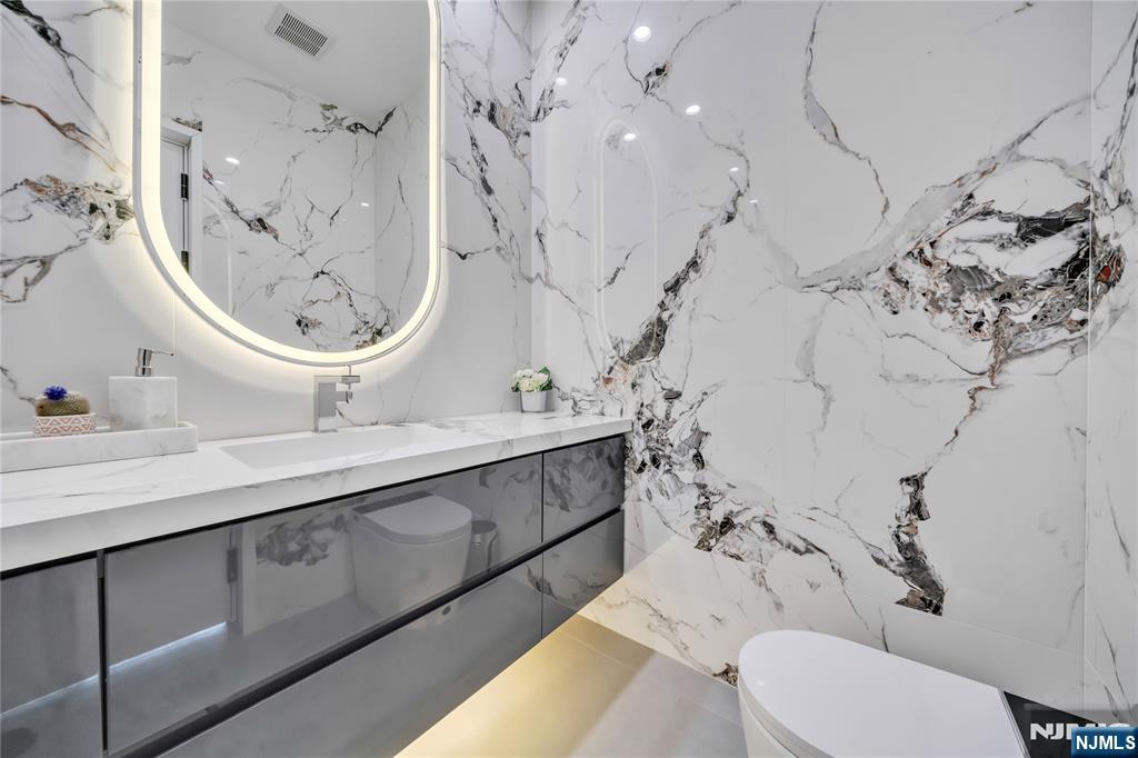 11 Roberts Road Englewood Cliffs, NJ 07632 - Photo 12 of 50 a bathroom with a sink vanity mirror and toilet