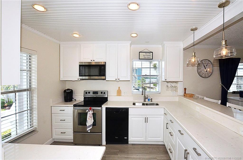 1866 Southwest Palm City Road, Unit 201 Stuart, FL 34994 - Photo 5 of 33 REMODELED KITCHEN - NO WALL JUST A BREAKFAST BAR SEPERATES THE KITCHEN FROM THE DINING AREA
