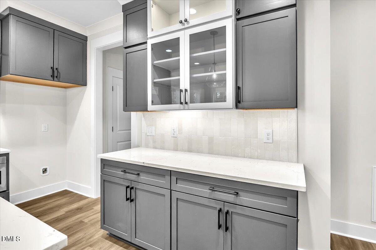 12916 Mallard Rock Road Zebulon, NC 27597 - Photo 11 of 68 a view of cabinets and wooden floor