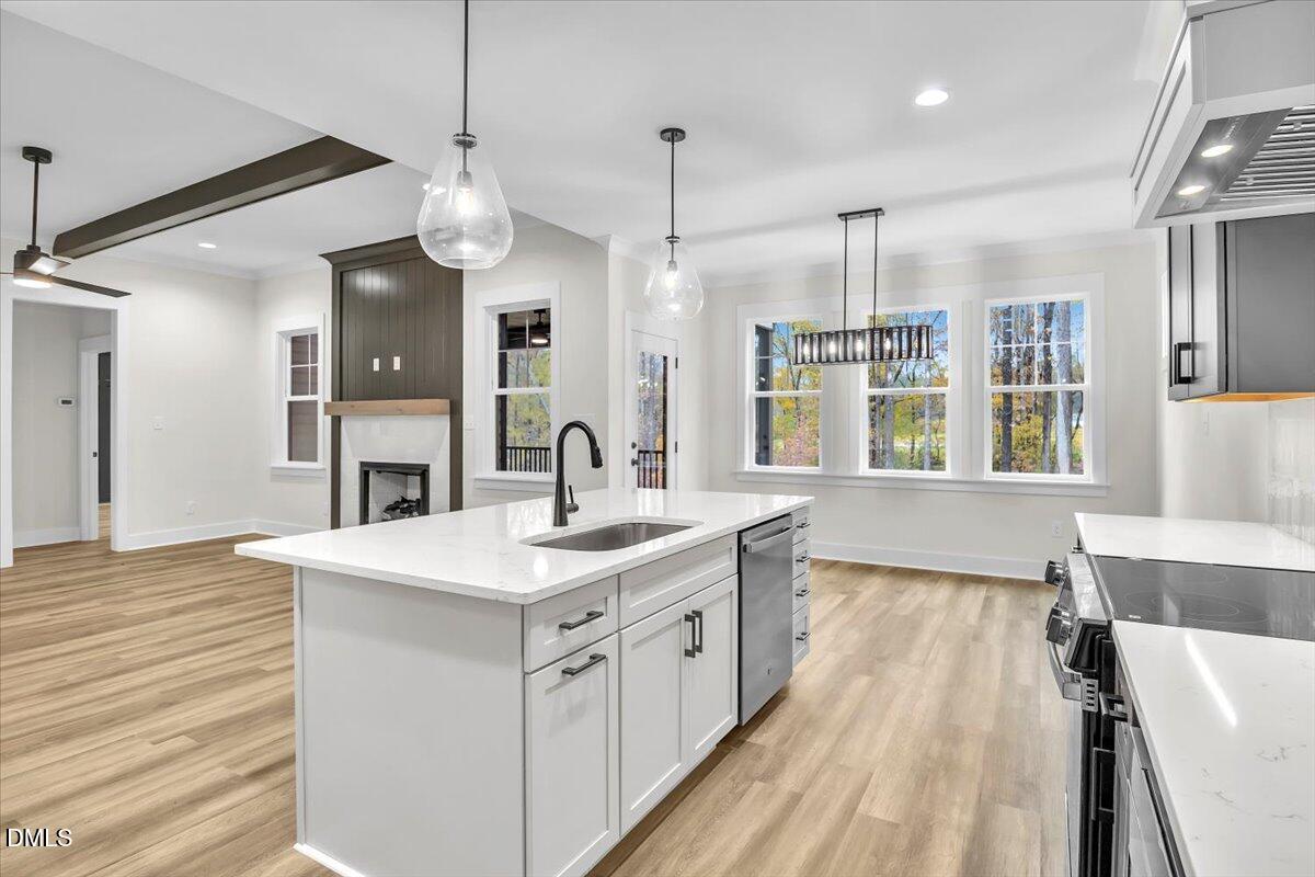12916 Mallard Rock Road Zebulon, NC 27597 - Photo 12 of 68 a kitchen with a sink stove and wooden floor