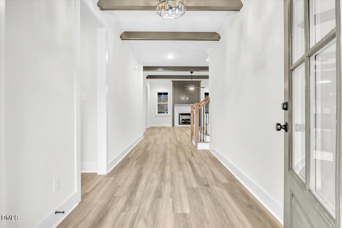 12916 Mallard Rock Road Zebulon, NC 27597 - Photo 2 of 68 a view of a hallway with wooden floor and staircase